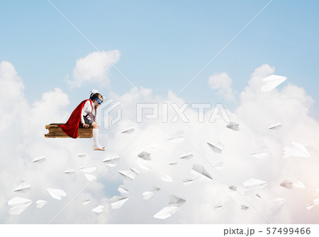Girl power concept with cute kid guardian against cloudscape background 57499466