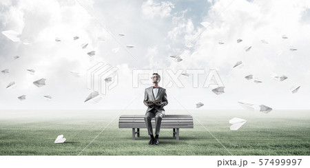 Young businessman or student studying the science and paper planes fly around Young businessman or student studying the science and paper planes fly around 57499997