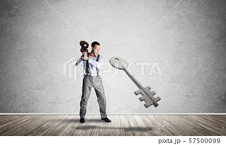 Breaking through access concept with man in room crashing concrete key Breaking through access concept with man in room crashing concrete key 57500099