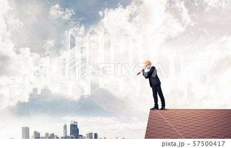 Engineer man standing on roof and looking in spyglass. Mixed med Engineer man standing on roof and looking in spyglass. Mixed med 57500417