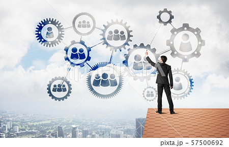 Businessman on house roof presenting teamwork and connection concept. Mixed media 57500692