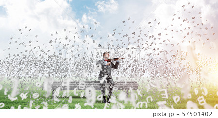 Handsome violinist in park on wooden bench play his melody 57501402