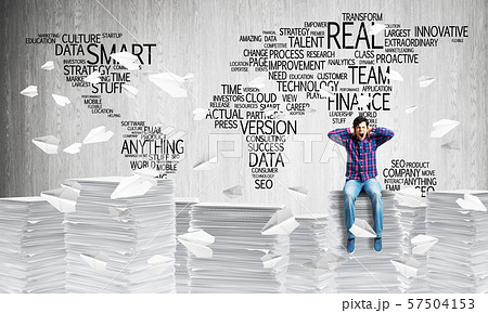 Attractive man sitting on pile of paper documents. Attractive man sitting on pile of paper documents. 57504153