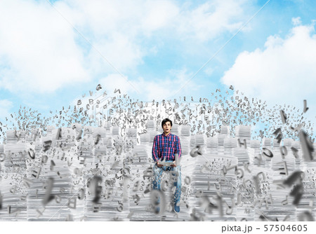 Attractive man sitting on pile of paper documents. Attractive man sitting on pile of paper documents. 57504605
