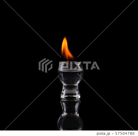 Glass of tequila and flames Glass of tequila and flames 57504780