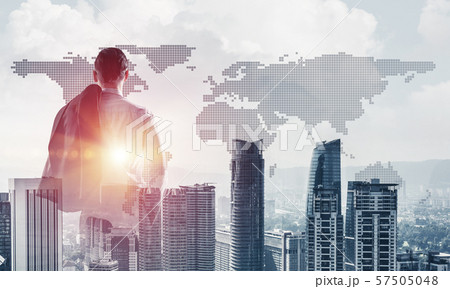 Concept of business success and control with confident boss against cityscape background Concept of business success and control with confident boss against cityscape background 57505048