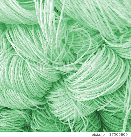 Some skeins of natural raffia on shelf. Natural 57506609