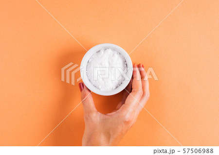 Baking soda in bowl on orange 57506988