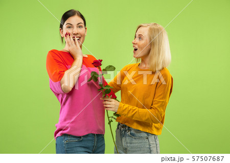 Portrait of pretty girls isolated on green studio background Portrait of pretty girls isolated on green studio background 57507687