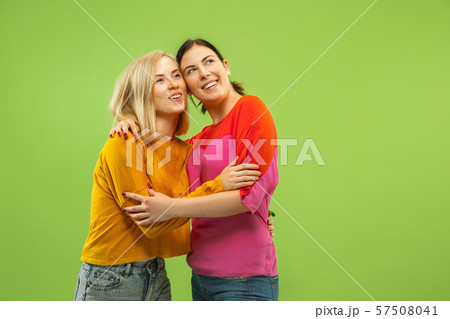 Portrait of pretty girls isolated on green studio background Portrait of pretty girls isolated on green studio background 57508041
