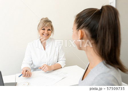 Beautiful woman gynecologist is conducting a Beautiful woman gynecologist is conducting a 57509735