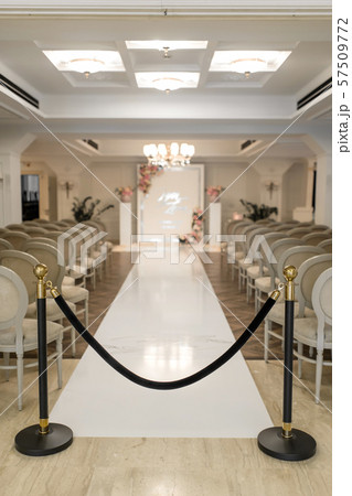 Wedding Hall. Rows of white festive chairs for 57509772