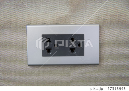 Grey universal electricity sockets plug on a yellow wall. Grey universal electricity sockets plug on a yellow wall. 57513943