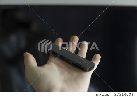 Man's hand holding The USB adapter under the Type-C connector for laptop. Multiport station for 57514003