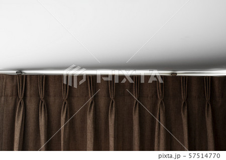 Brown curtains on a rail with a white ceiling. Curtain interior decoration in living or sleeping 57514770