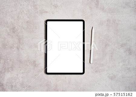 Tablet and pencil on grey concrete background. 57515162