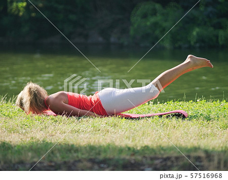 Woman Doing Yoga in the Park 57516968