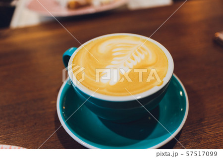 Cup of coffee on wooden table, top view. 57517099