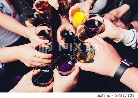 Clinking glasses with alcohol and toasting, party. Congratulations to the event. Cheerful party 57517108