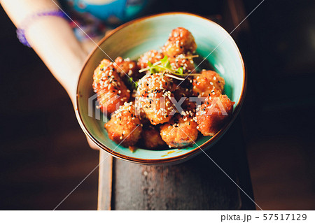 Close up a Japanese sushi on a black tray and selling at the night market with dark background. 57517129