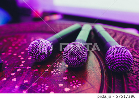 three Microphones in group on red table with copy space. three Microphones in group on red table with copy space. 57517396
