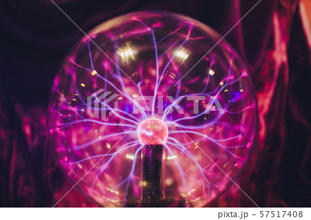 Hand touching a plasma ball with smooth magenta-blue flames. Hand touching a plasma ball with smooth magenta-blue flames. 57517408