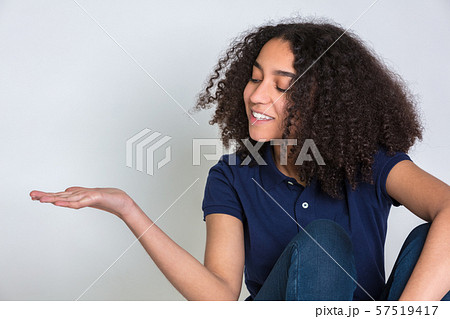 Biracial African American Teenager Teen Young Woman Holding Out Empty Hand 57519417