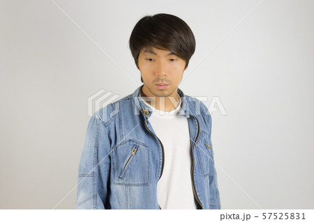 Young Asian Man in Jeans or Denim Jacket Looking Below at Front View 57525831