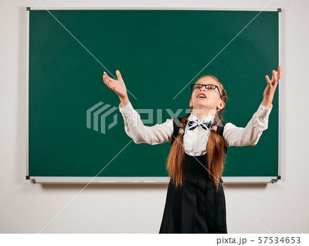 Portrait of a schoolgirl playing with backpack and 57534653