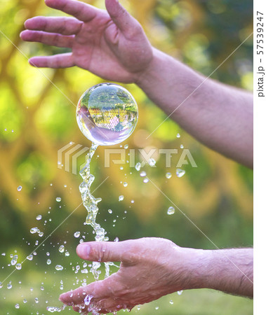 throwing a glass ball into the air throwing a glass ball into the air 57539247
