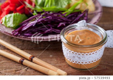 Vegetable salad with asian peanut coconut dressing 57539493