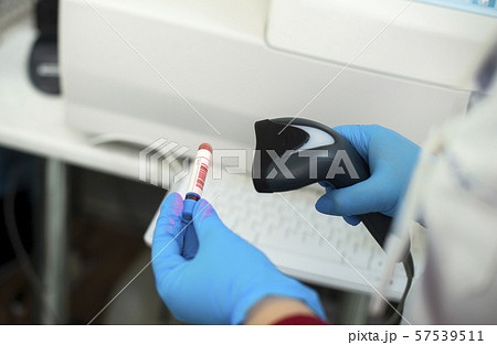 Bar code scanner and test tube over monitor Bar code scanner and test tube over monitor 57539511