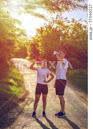 Couple of runners resting while training Couple of runners resting while training 57540517