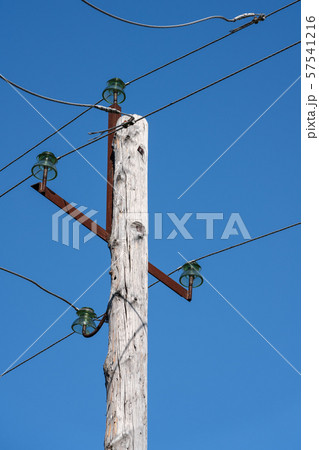 Old wooden high voltage post or high voltage tower in sunny day Old wooden high voltage post or high voltage tower in sunny day 57541216