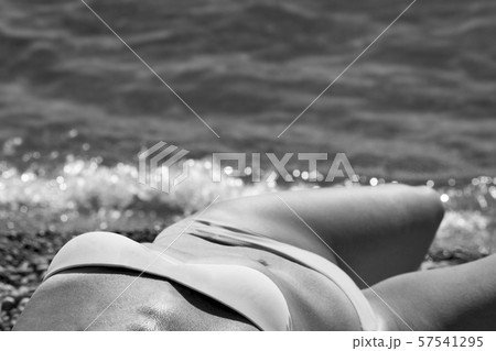 the beautiful girl in surf splashes on the beach 57541295