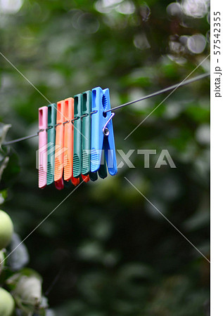 Clothespins on a rope hanging outside house and 57542355