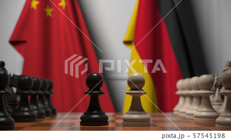 Flags of China and Germany behind chess board. The first pawn moves in the beginning of the game 57545198