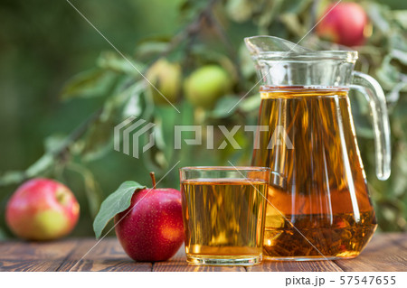 apple juice in glass and jug apple juice in glass and jug 57547655