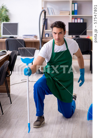 Young handsome contractor cleaning the office 57547801