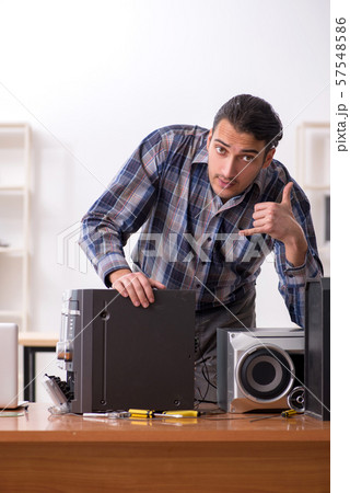Young engineer repairing musical hi-fi system Young engineer repairing musical hi-fi system 57548586