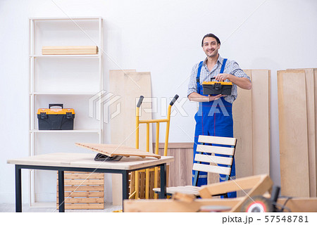 Young male carpenter working indoors Young male carpenter working indoors 57548781