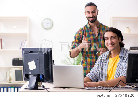 Two it specialists working in the office Two it specialists working in the office 57548820