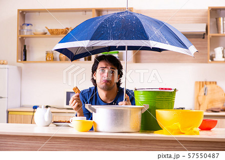 Young man in water leakage from the neighbors concept 57550487