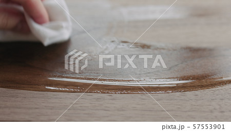 woodworker applying oil finish to black walnut board 57553901