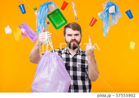 Problem of trash, plastic recycling, pollution and environmental concept - angry man holding garbage 57553902