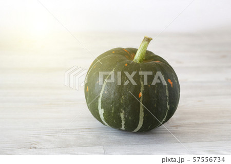 Green ripe pumpkin on a light background. Autumn harvest. Halloween Green ripe pumpkin on a light background. Autumn harvest. Halloween 57556734