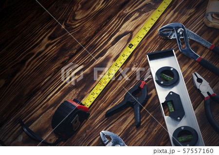 Close up tools on a wooden background. Close up tools on a wooden background. 57557160