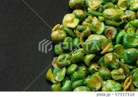 The salted peas on black Ceramic Plate close up image. The salted peas on black Ceramic Plate close up image. 57557310