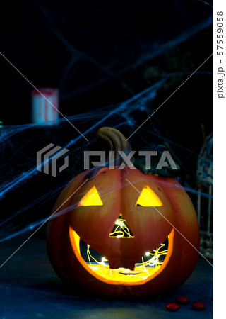 Halloween pumpkin with scary on the window at night Halloween pumpkin with scary on the window at night 57559058