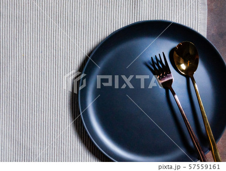 Empty plate with spoon and fork on Napery 57559161
